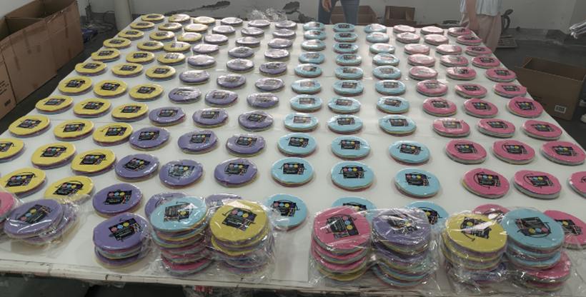 Round color-block paper coasters sorted by color for inspection